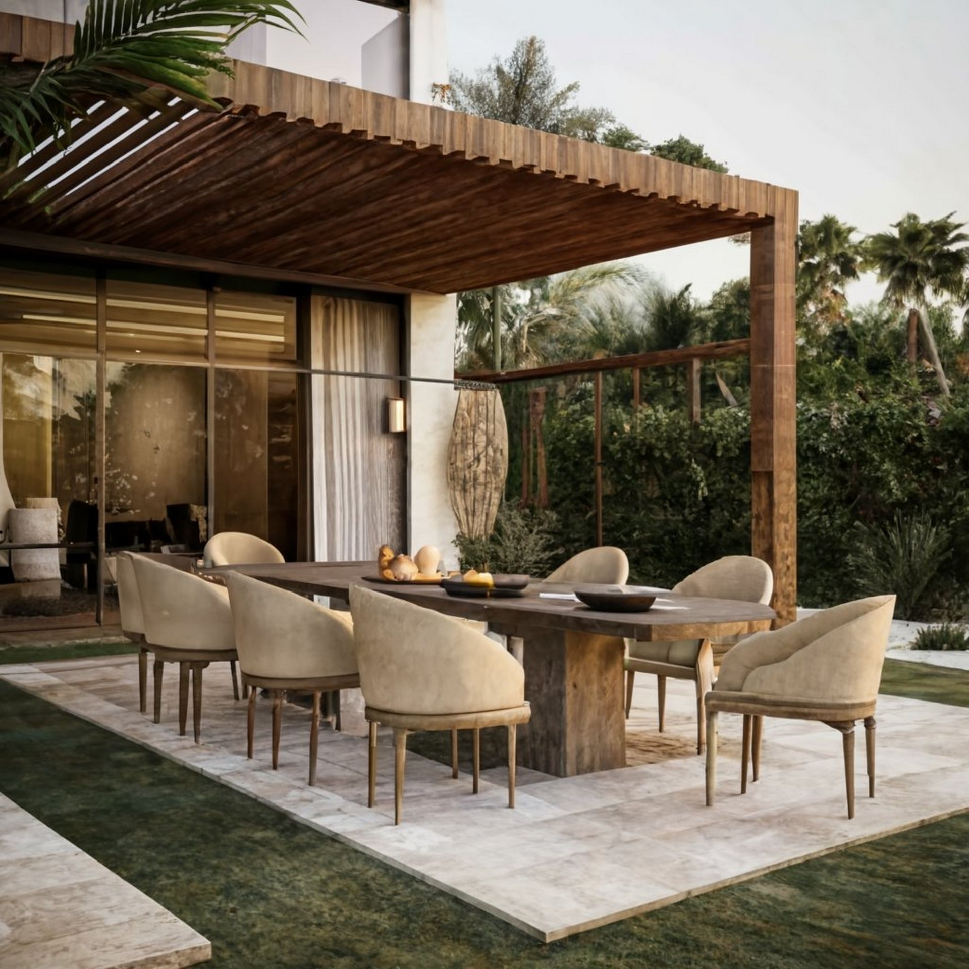 Outdoor dining table under a wooden pergola with ten beige chairs, lush greenery, and a modern home.