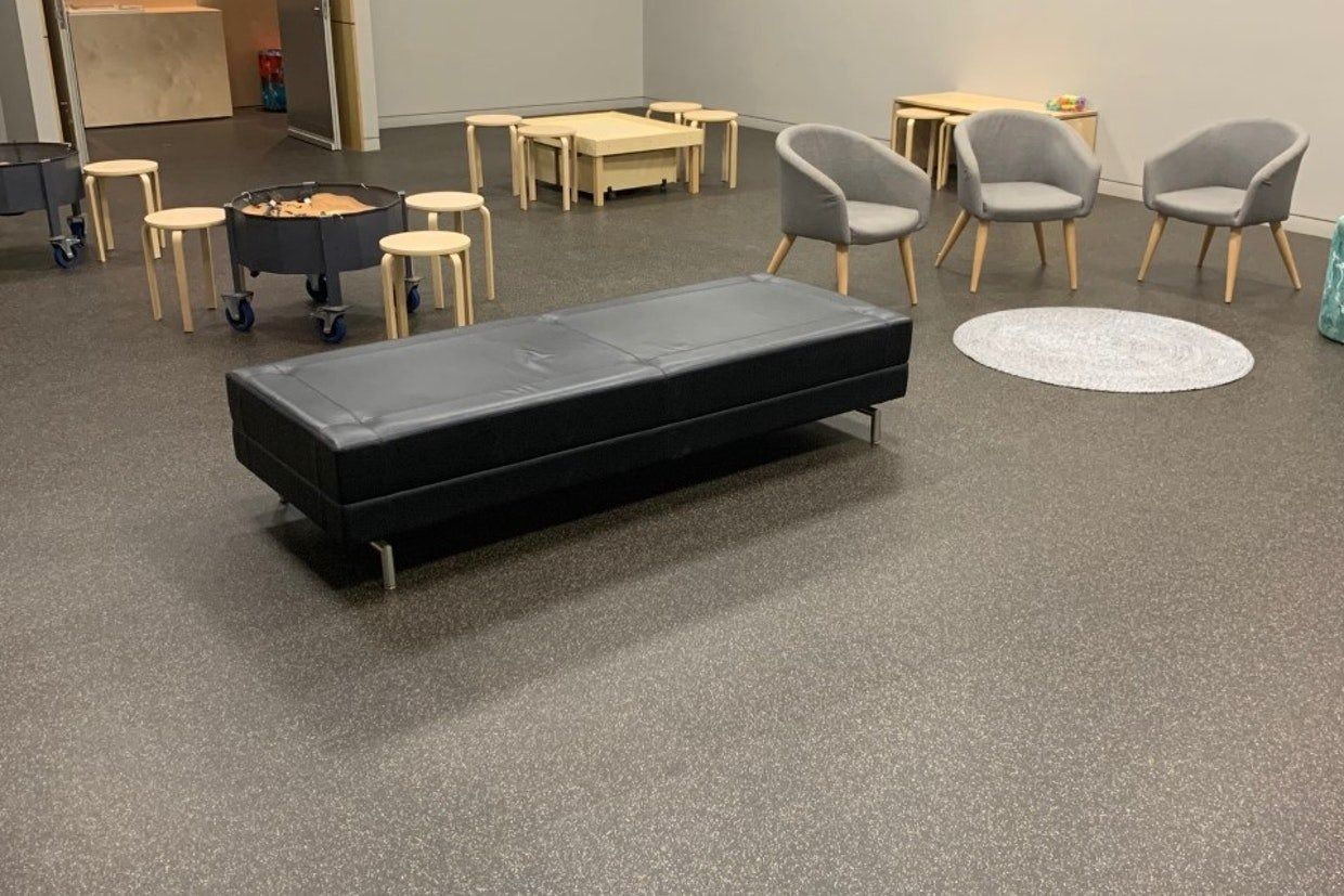 A Room With Furniture, Including a Black Bench, Grey Chairs and Small Stools — Ozwide Flooring In Ciccone, NT