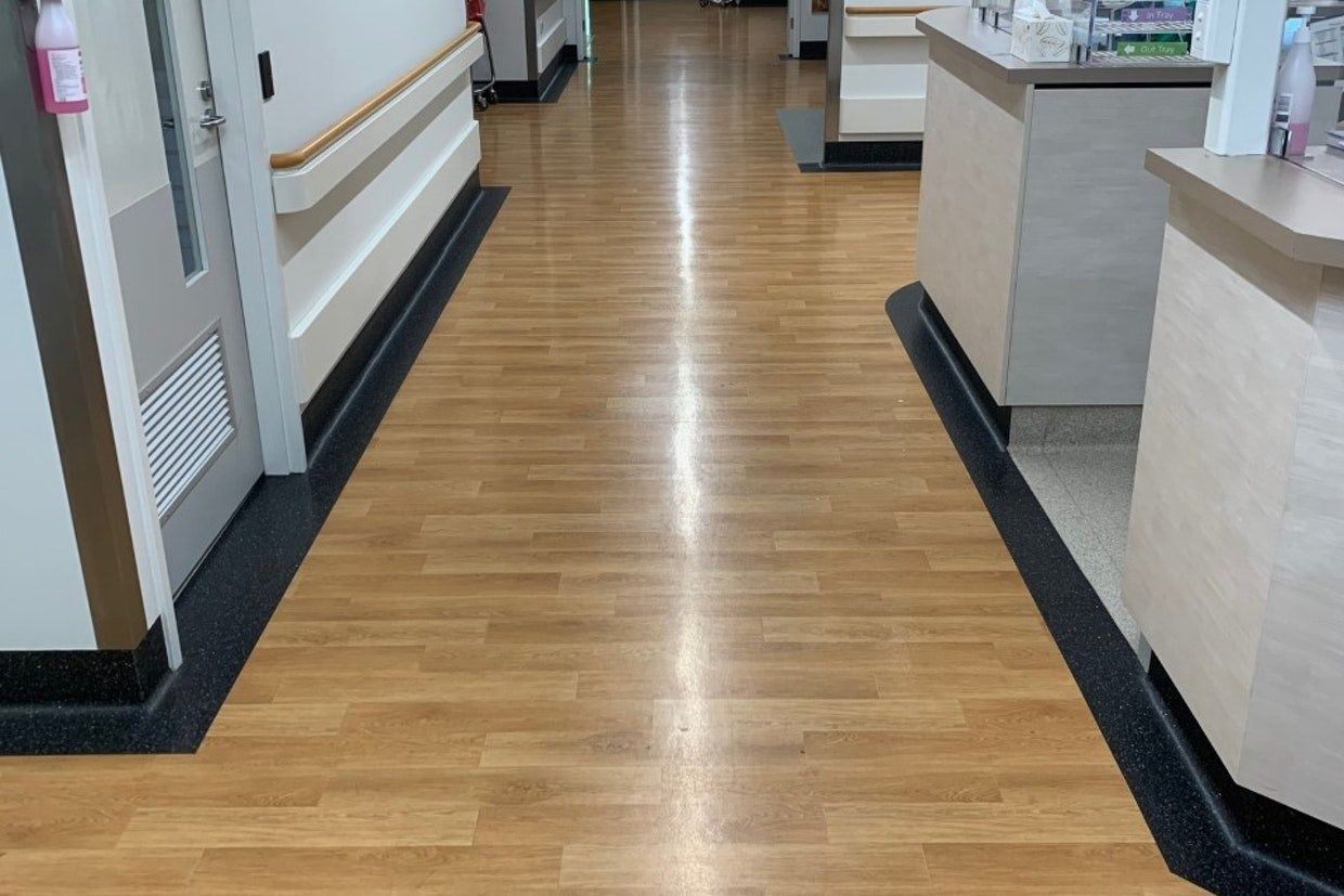 Hospital Hallway With Wood-look Flooring, Counters, and Doors — Ozwide Flooring In Ciccone, NT