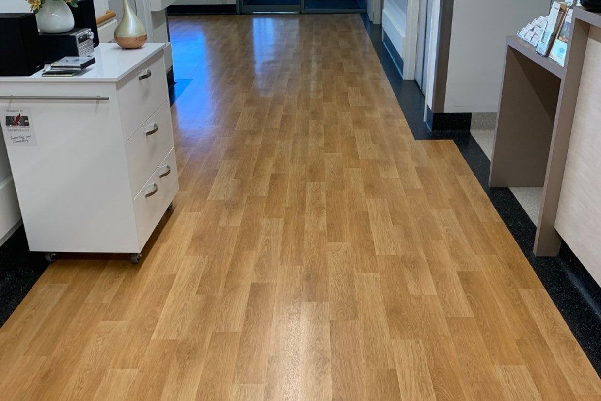 Wooden Floor in a Hallway With a White Cabinet on the Left — Ozwide Flooring In Ciccone, NT