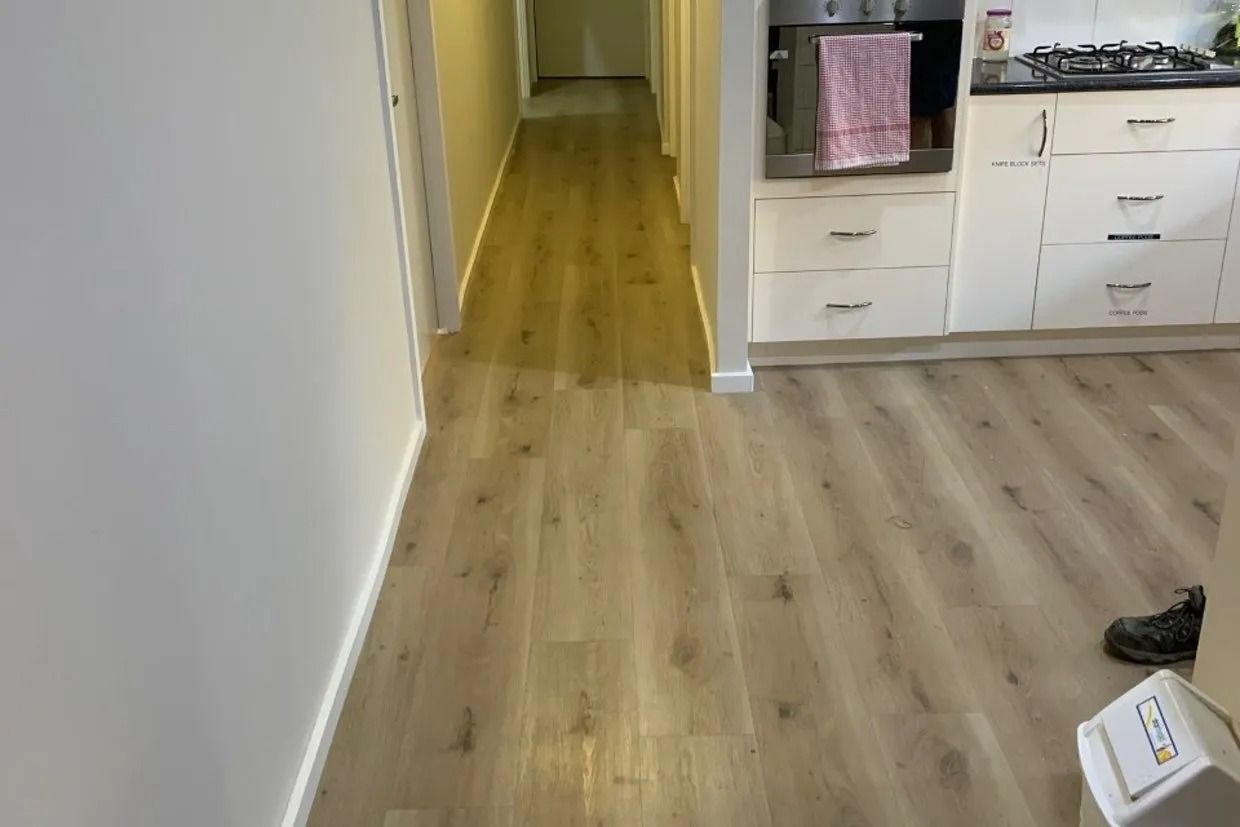 Hallway With Light Wood-look Flooring and White Walls — Ozwide Flooring In Ciccone, NT