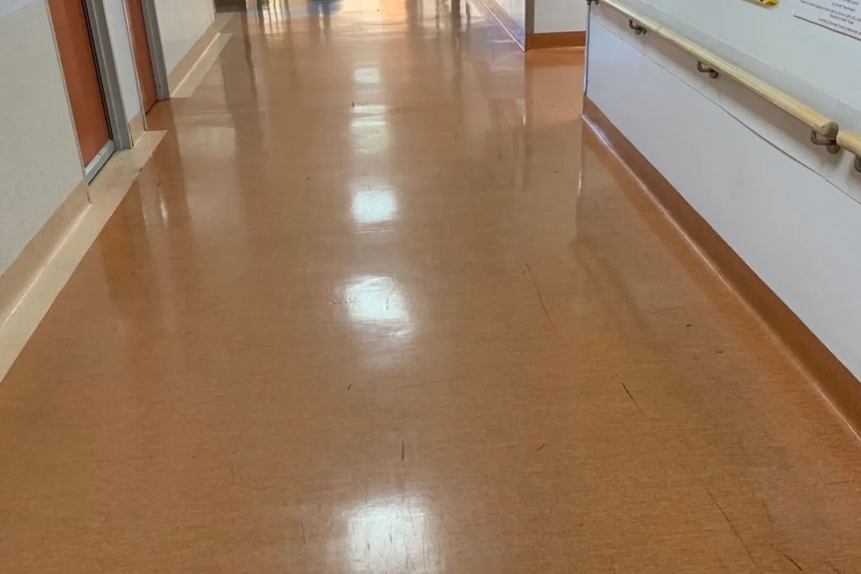 Hallway With Shiny, Tan Floor; White Wall With a Handrail on the Right — Ozwide Flooring In Ciccone, NT