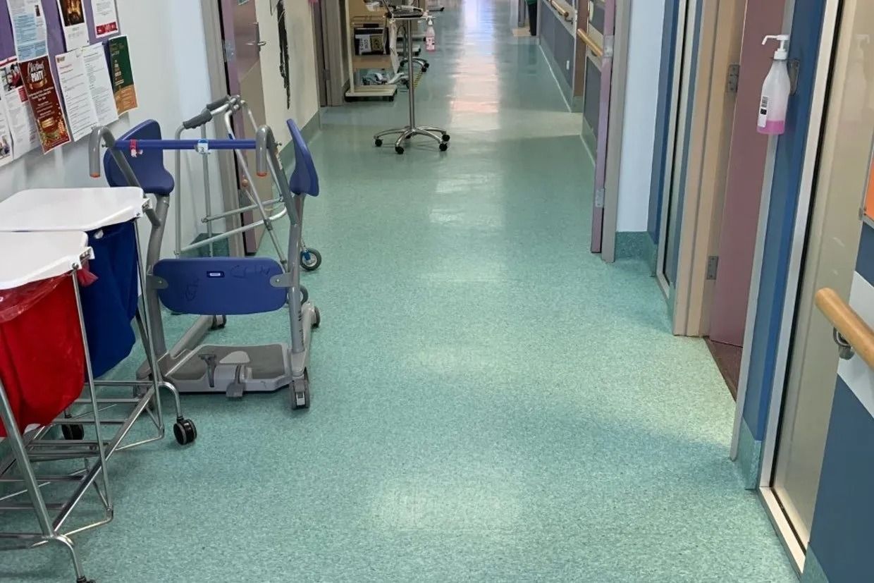 Hospital Hallway With Blue-green Speckled Floor, Medical Equipment, and Closed Doors — Ozwide Flooring In Ciccone, NT