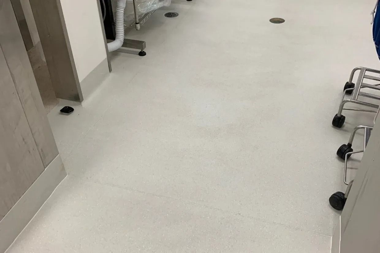 White Hallway Floor With Equipment and Dark Round Fixtures — Ozwide Flooring In Ciccone, NT
