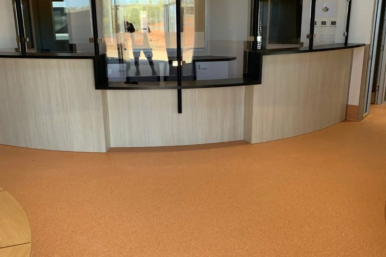 Orange Floor in Front of a Light-coloured Counter With Clear Glass Dividers — Ozwide Flooring In Ciccone, NT