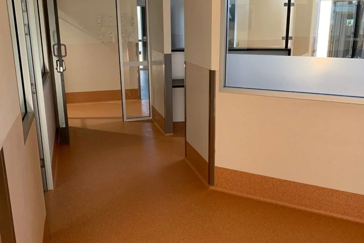 Hallway With Orange Floor and Light Peach Walls — Ozwide Flooring In Ciccone, NT