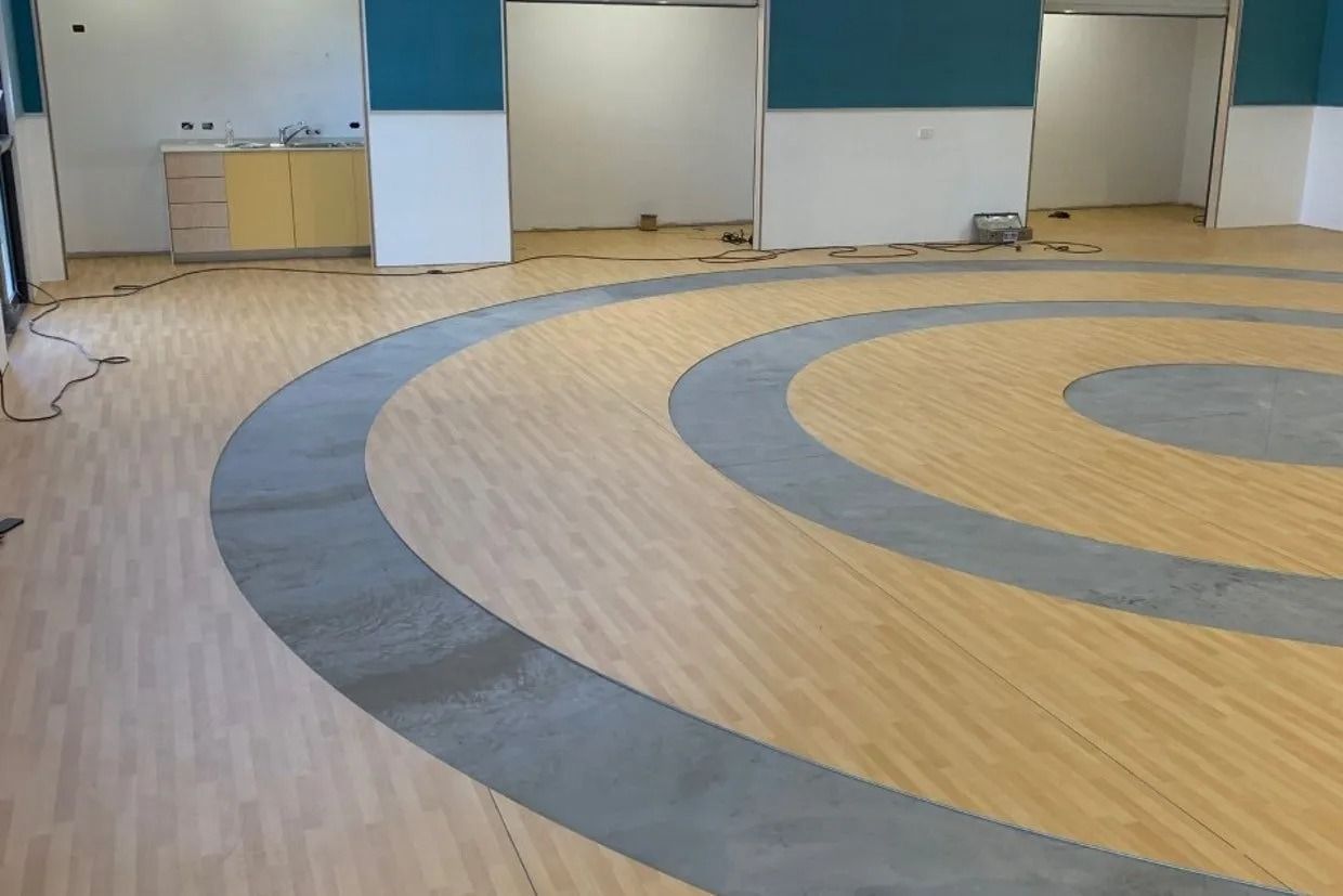 Wooden Floor With Grey Concentric Circles — Ozwide Flooring In Ciccone, NT
