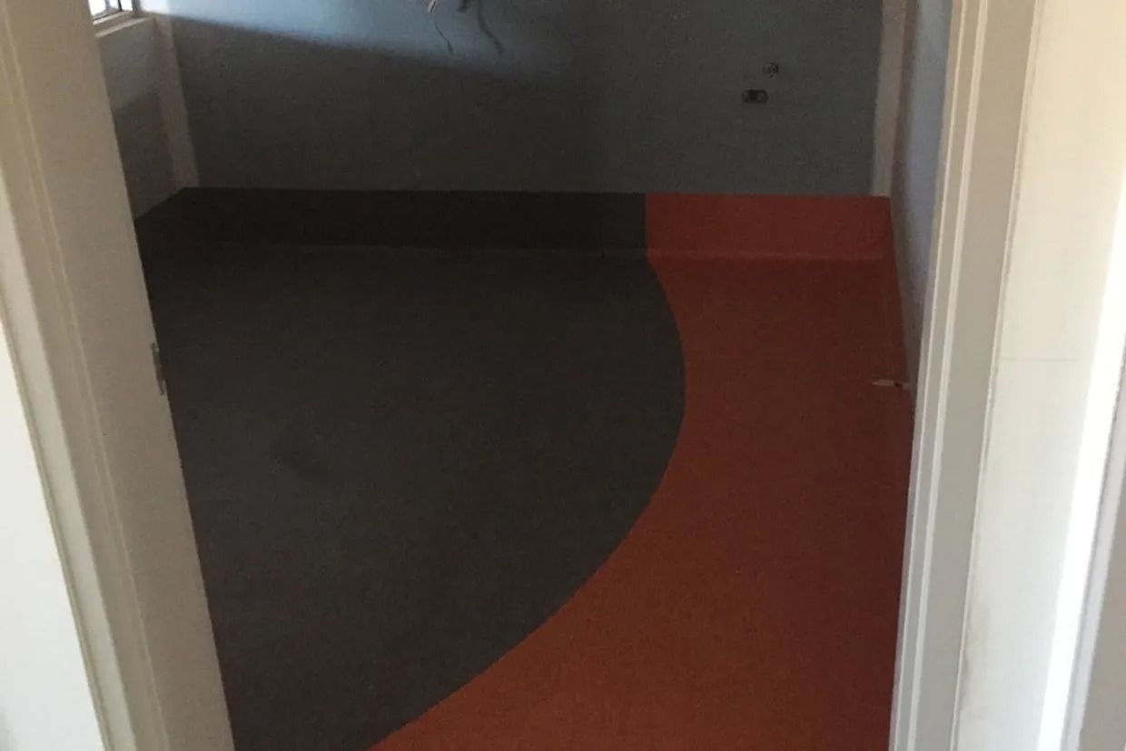 Room With Grey and Orange Flooring, Seen Through a Doorway — Ozwide Flooring In Ciccone, NT