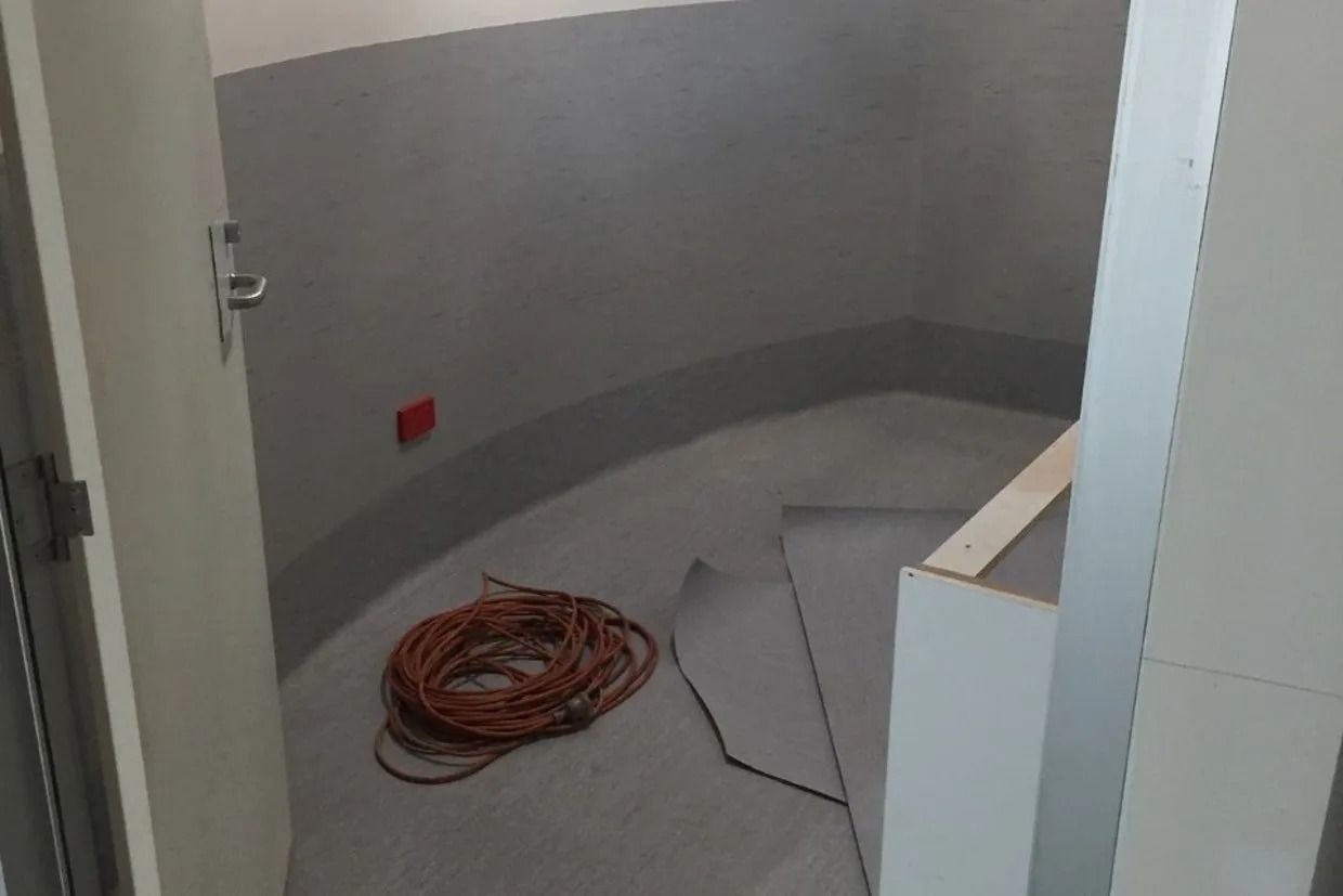 Interior of a Small Room Being Renovated; Grey Walls, Floor, and Trim — Ozwide Flooring In Ciccone, NT