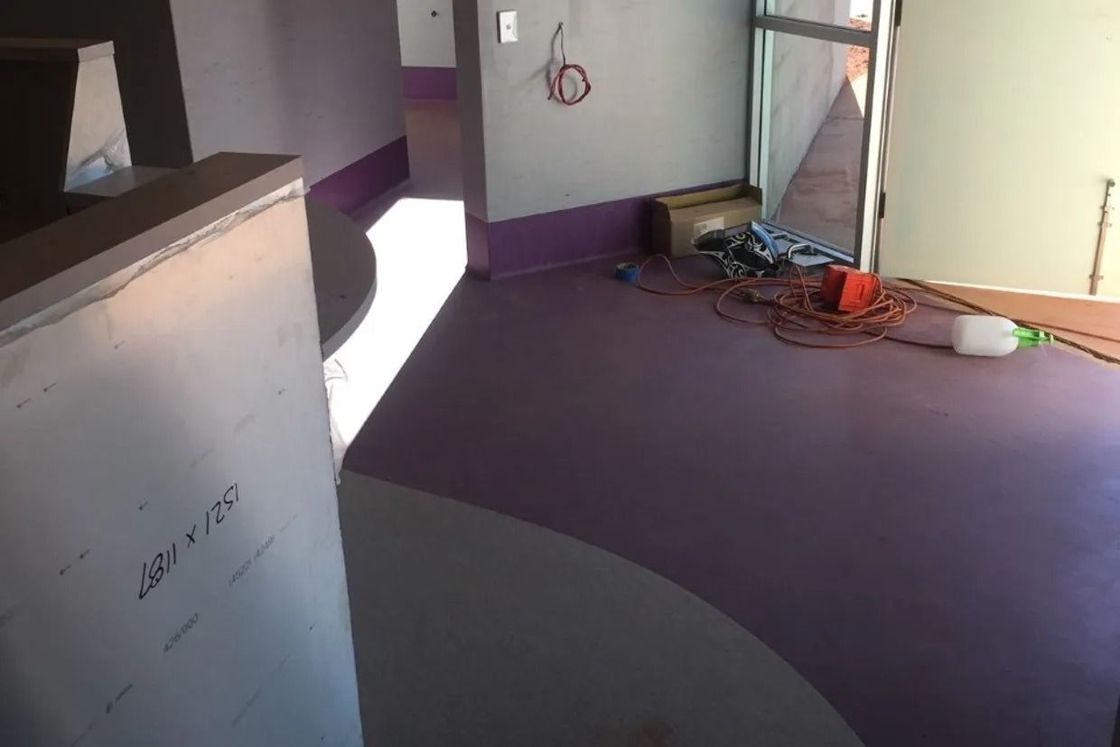Interior View of a Room Under Construction With Purple Flooring and White Walls — Ozwide Flooring In Ciccone, NT