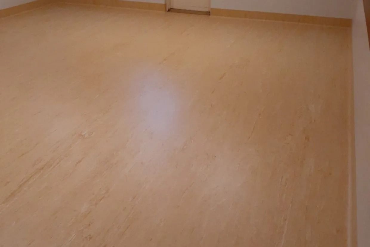 Tan Wall With a Light Patch and Small Vent Near the Top — Ozwide Flooring In Ciccone, NT