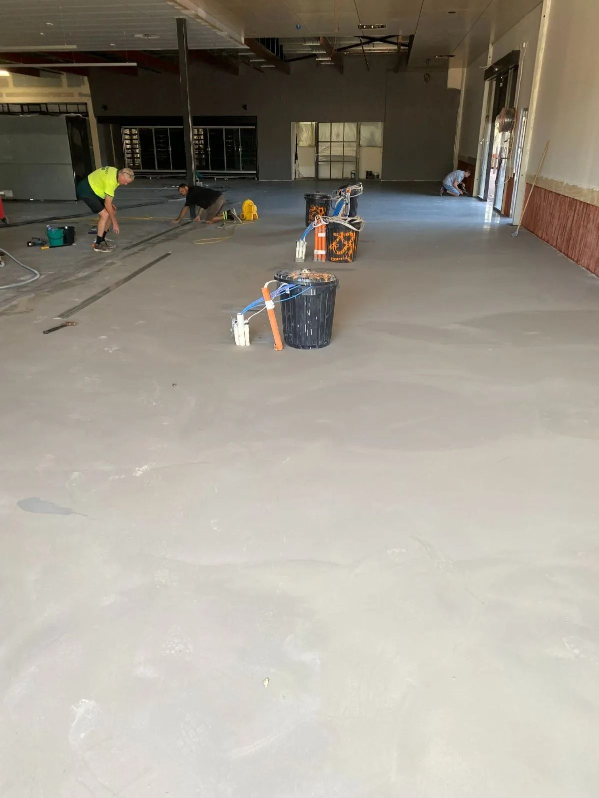 Construction Site: Workers Preparing a Concrete Floor — Ozwide Flooring In Ciccone, NT
