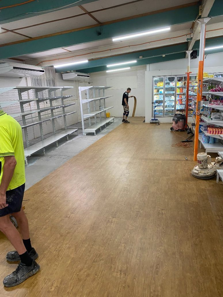 A Person in a Store With Shelves and Merchandise — Ozwide Flooring In Ciccone, NT