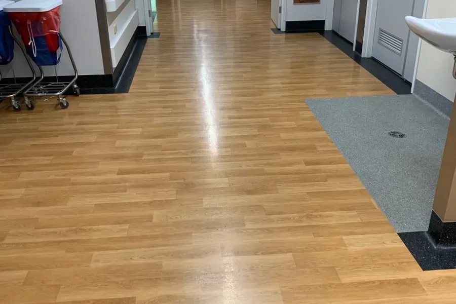 Hallway With Light Wood-look Flooring, Bordered by Black Trim — Ozwide Flooring In Ciccone, NT