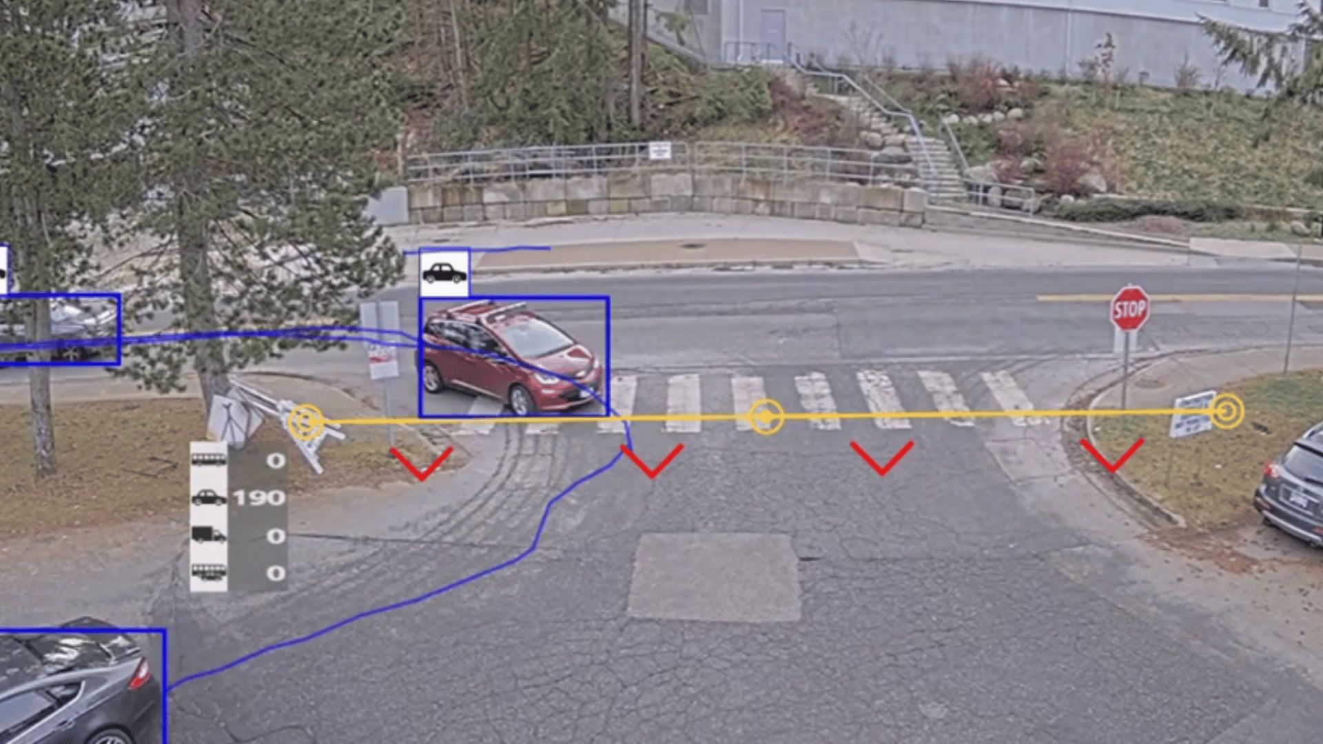 Street scene with parked cars, lane markings, and blue/yellow annotation boxes over the road.
