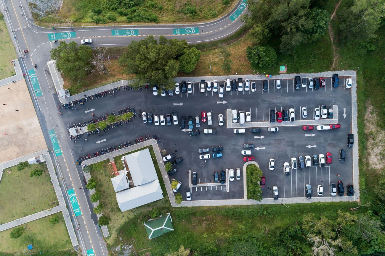 An aerial view of a parking lot filled with cars.