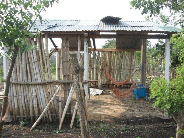 Typical Honduran home with hammocks to call their beds.