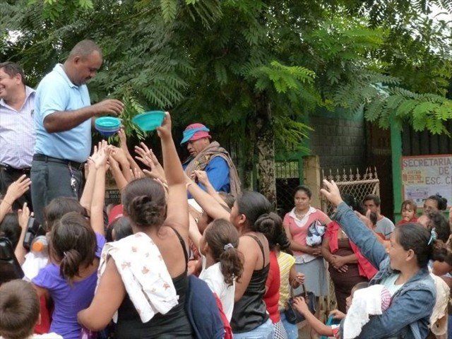 Julio distributing in a Honduran community some of the Mission of Love donations via the Denton airlift. Can you even imagine in need of a simple bowl? We as a society have so very much and in most cases never use what we have.