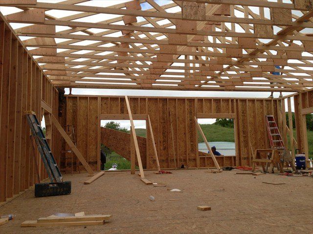 The inside of a building under construction with a ladder in the foreground at Pine Ridge Reservation