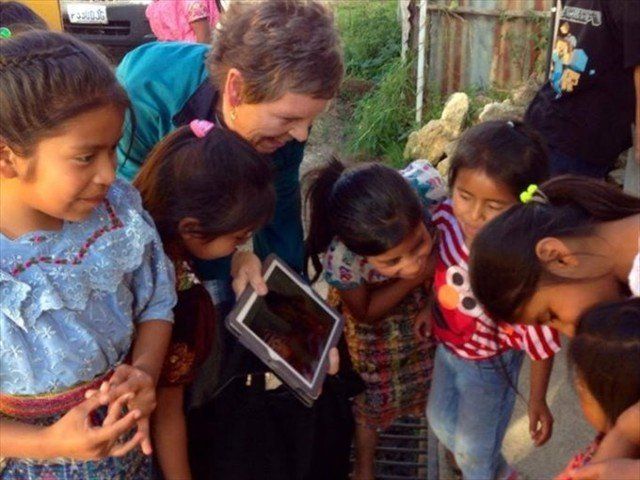 SUSAN AND FRANKIE SHARING PHOTOS OF THE MAYAN CHILDREN. THIS IS THE FIRST TIME THAT THEY EVER SAW A PHOTO OF THEMSELVES. PRICELESS!