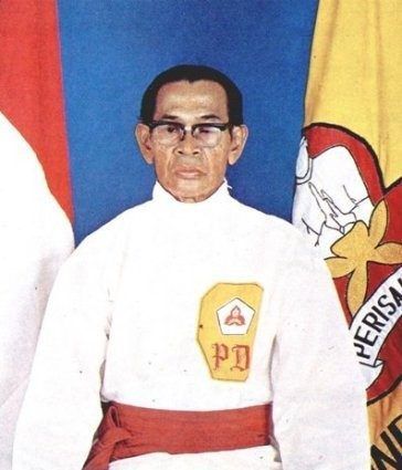 A man with glasses and a pd patch on his shirt