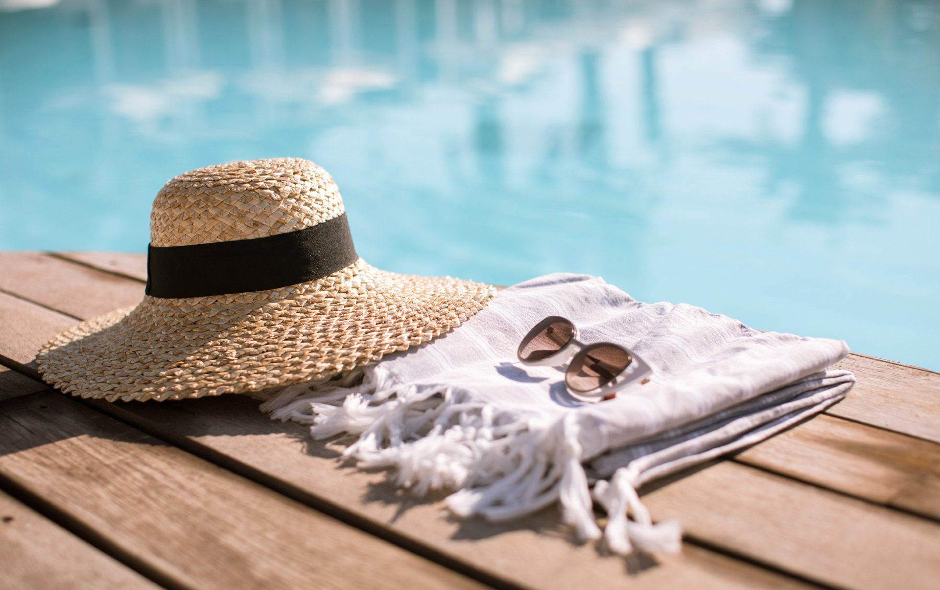 pool side with towel and hat next to it