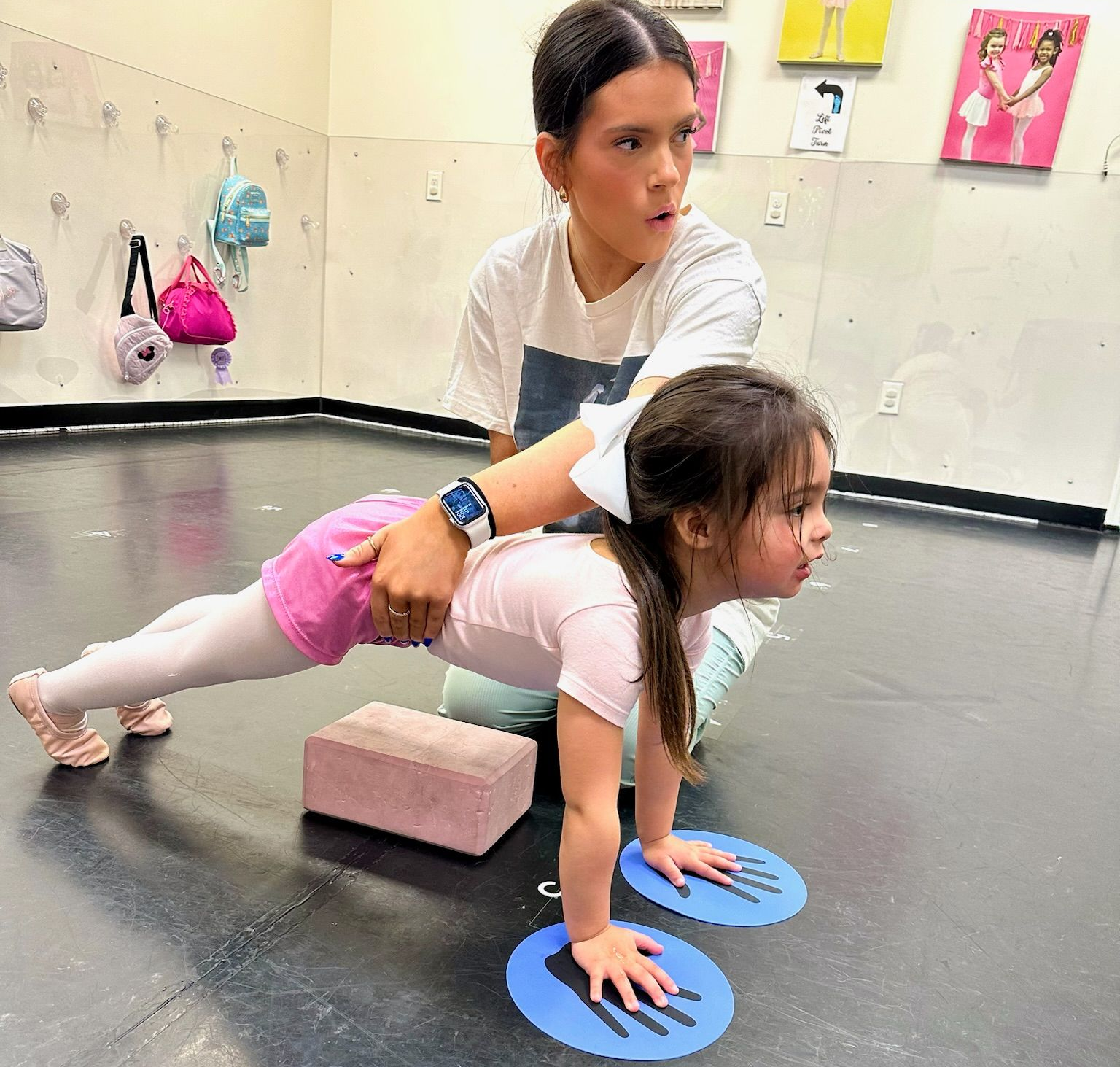 Instructing a dancer from the pre-school and kindergarten class