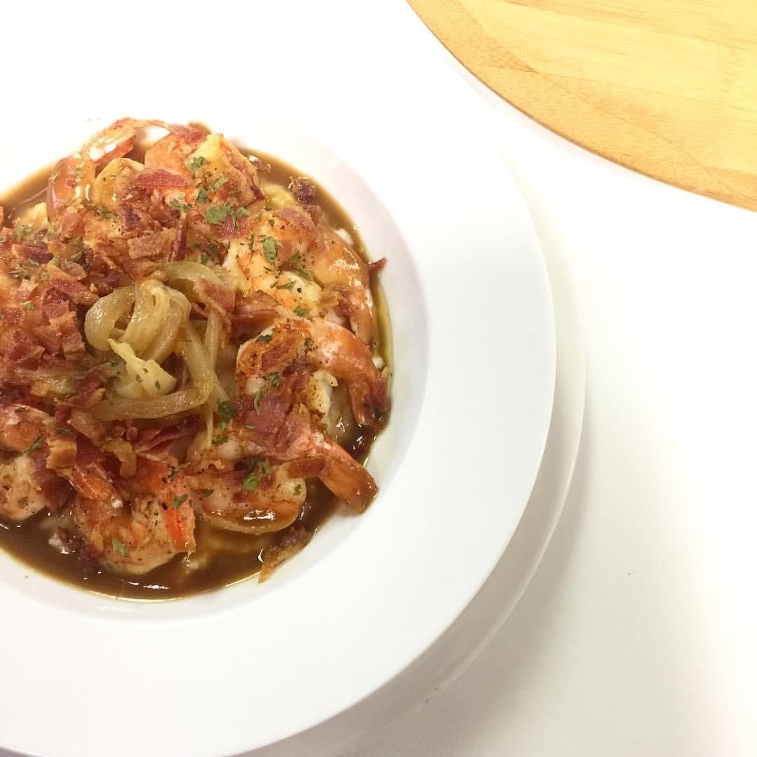 Plate of pasta with tomato sauce and herbs on a white dish