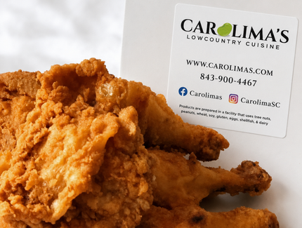 Fried chicken pieces on a white plate with a Carlina’s logo in the background