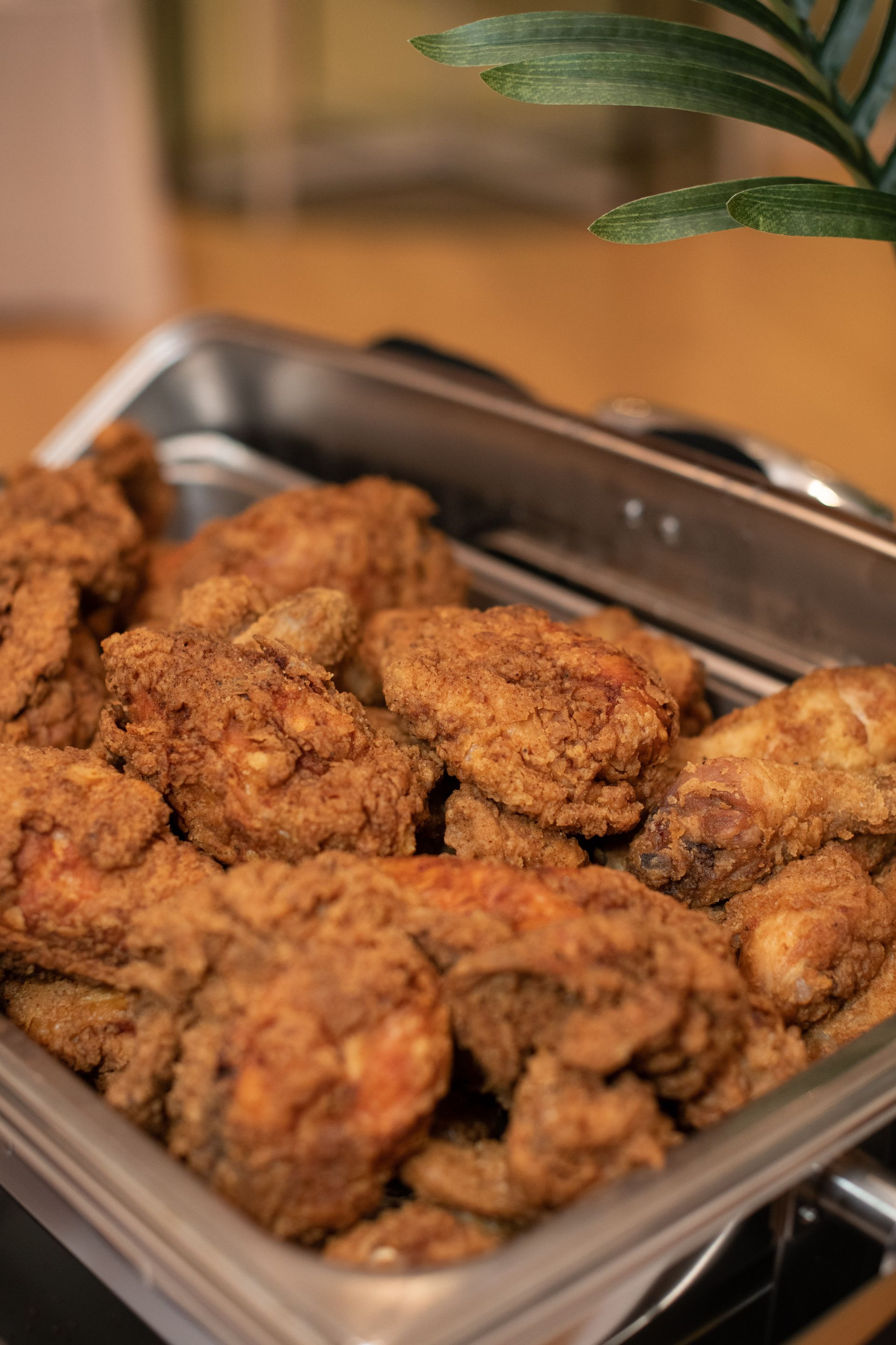 Tray of crispy fried chicken pieces on a table