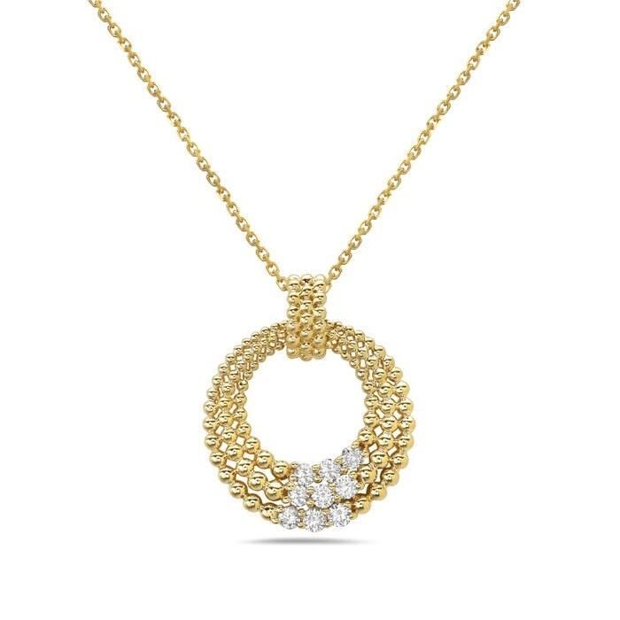 Gold necklace with a round pendant accented with small clear stones and a white floral detail