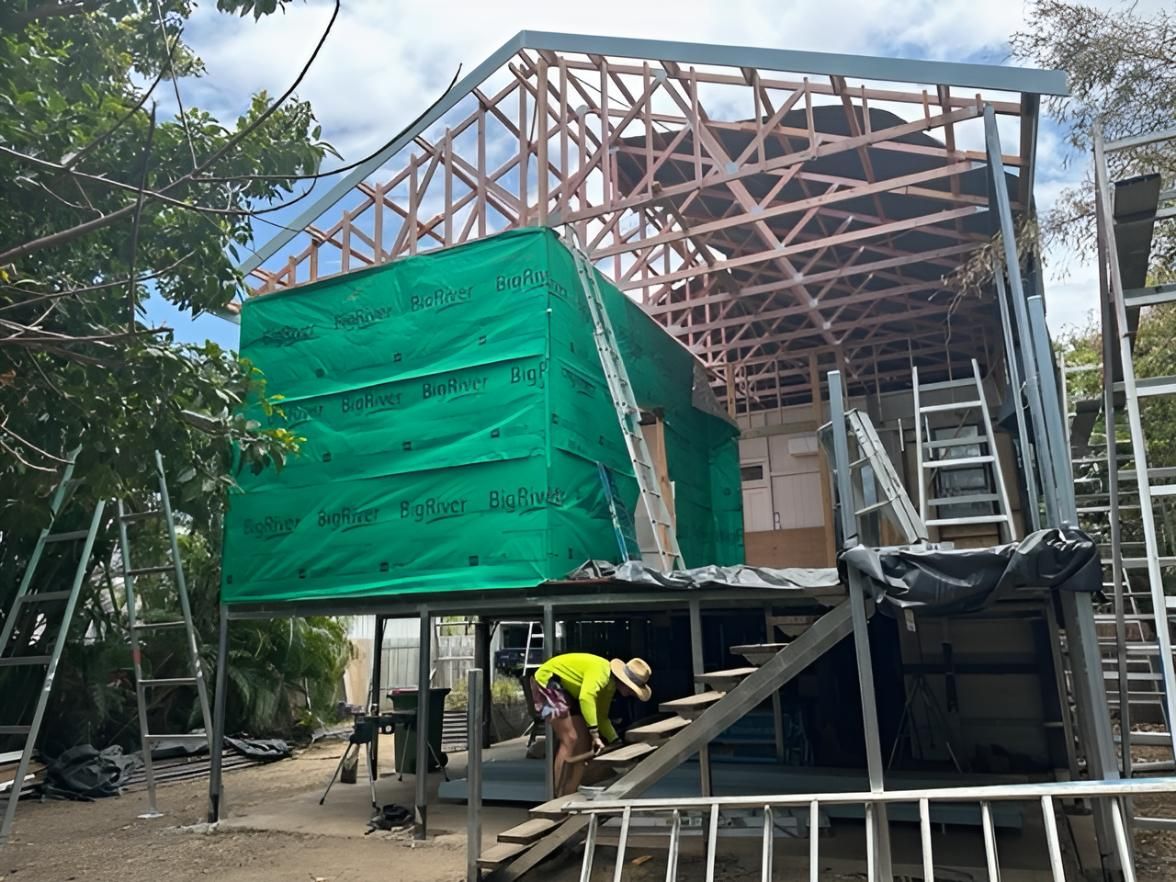 A Man is Working on the Stairs of a Building Under Construction — Shane Firmin Carpentry Pty Ltd In Mount St John, QLD