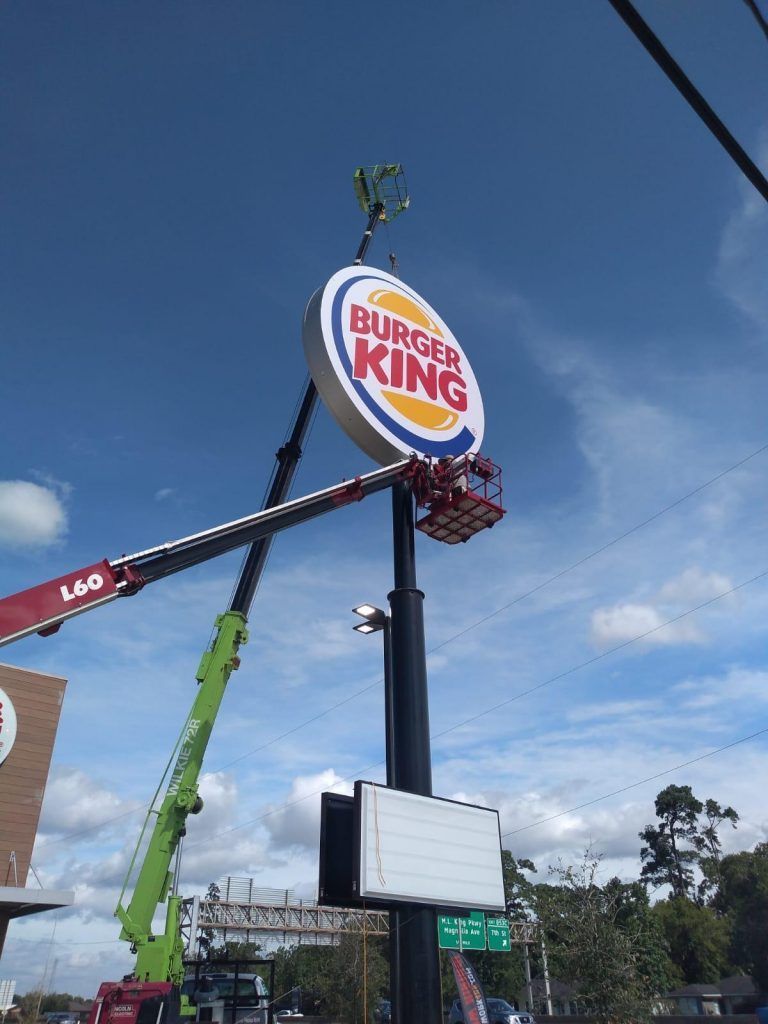 Craftech Signage Solutions team installing a custom storefront sign in Houston, TX