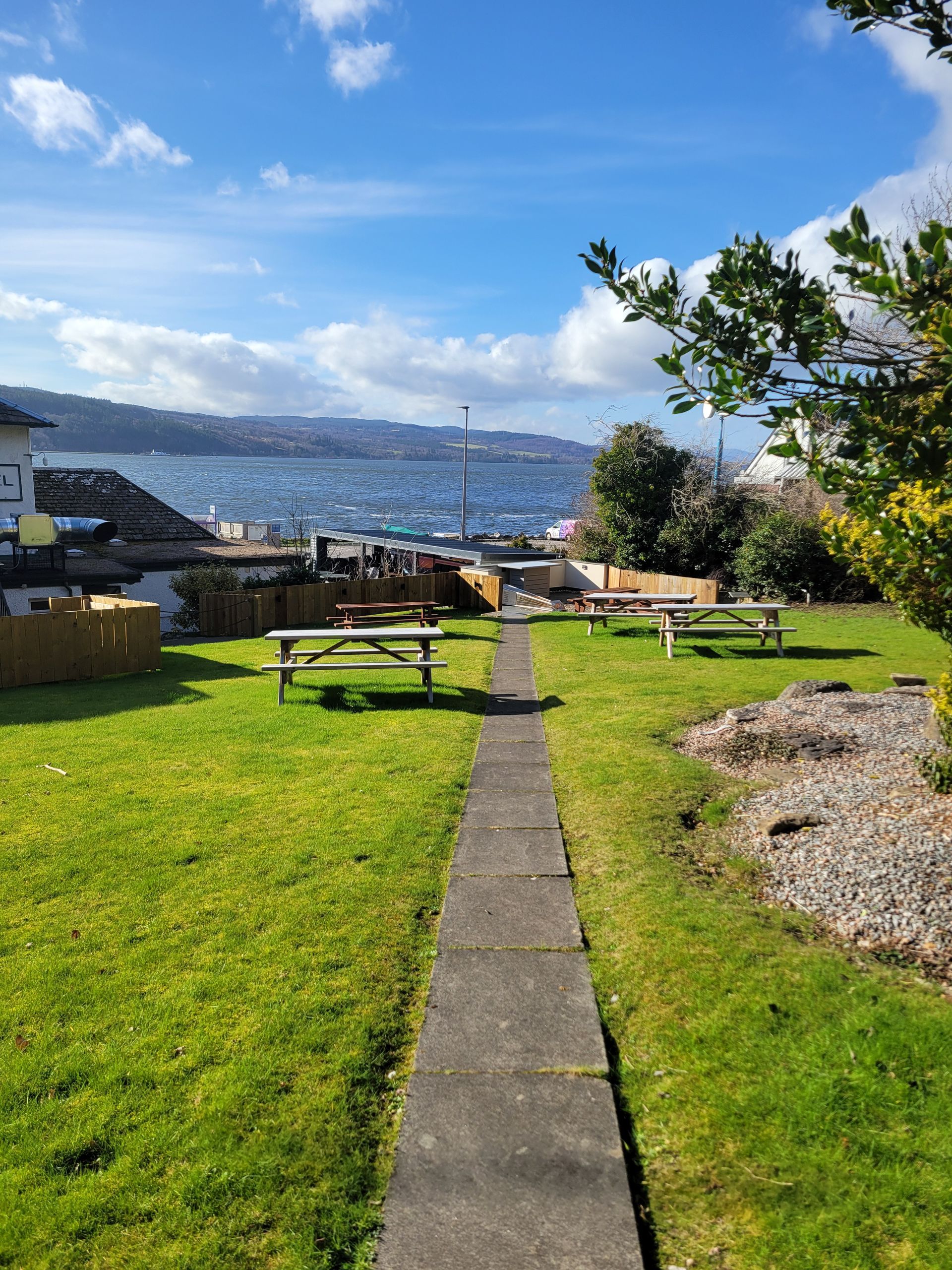 View of the Beauly Firth from the hotel rear garden looking over the hotel patio, veranda and enclosed kabin