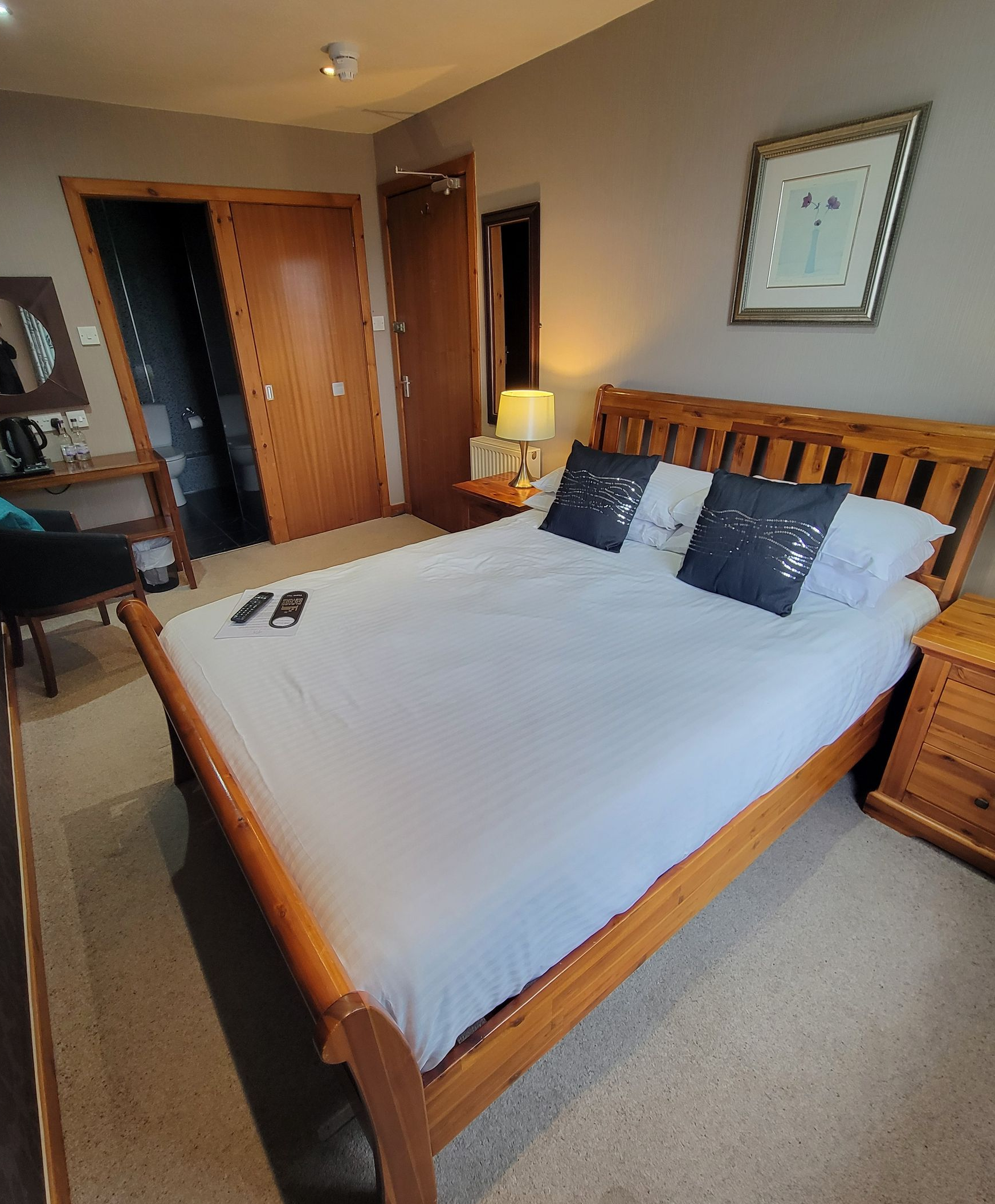A bedroom with a large bed and a window.