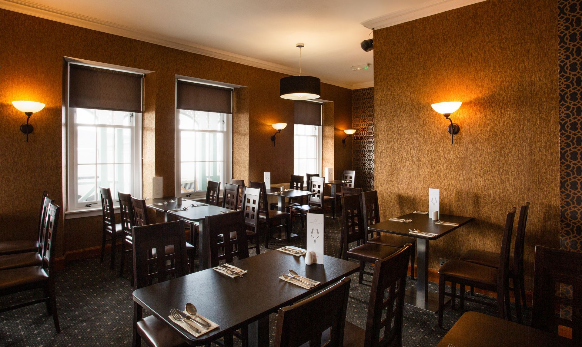 A restaurant with tables and chairs and a lot of windows