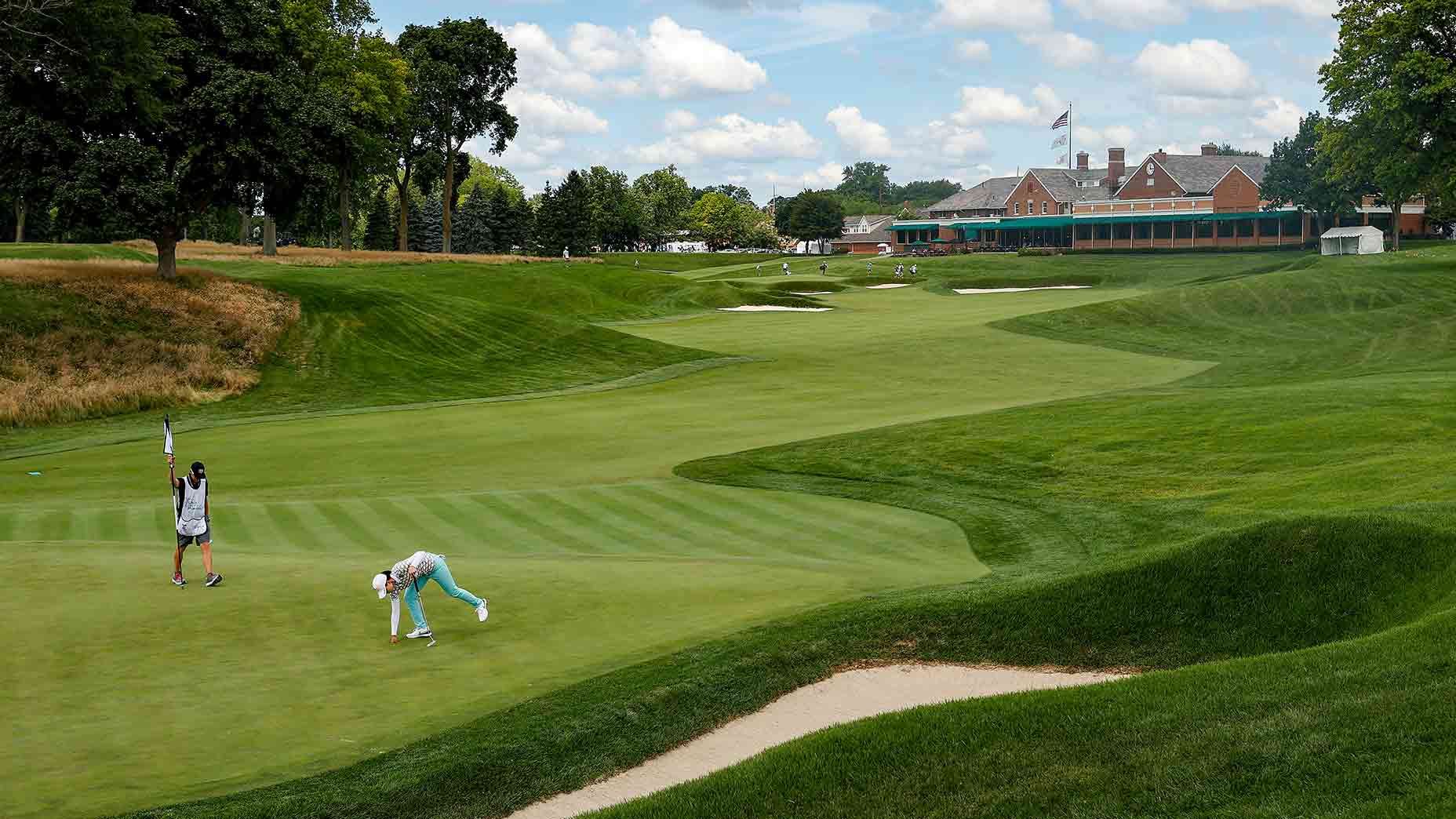 A group of people are playing golf on a golf course.