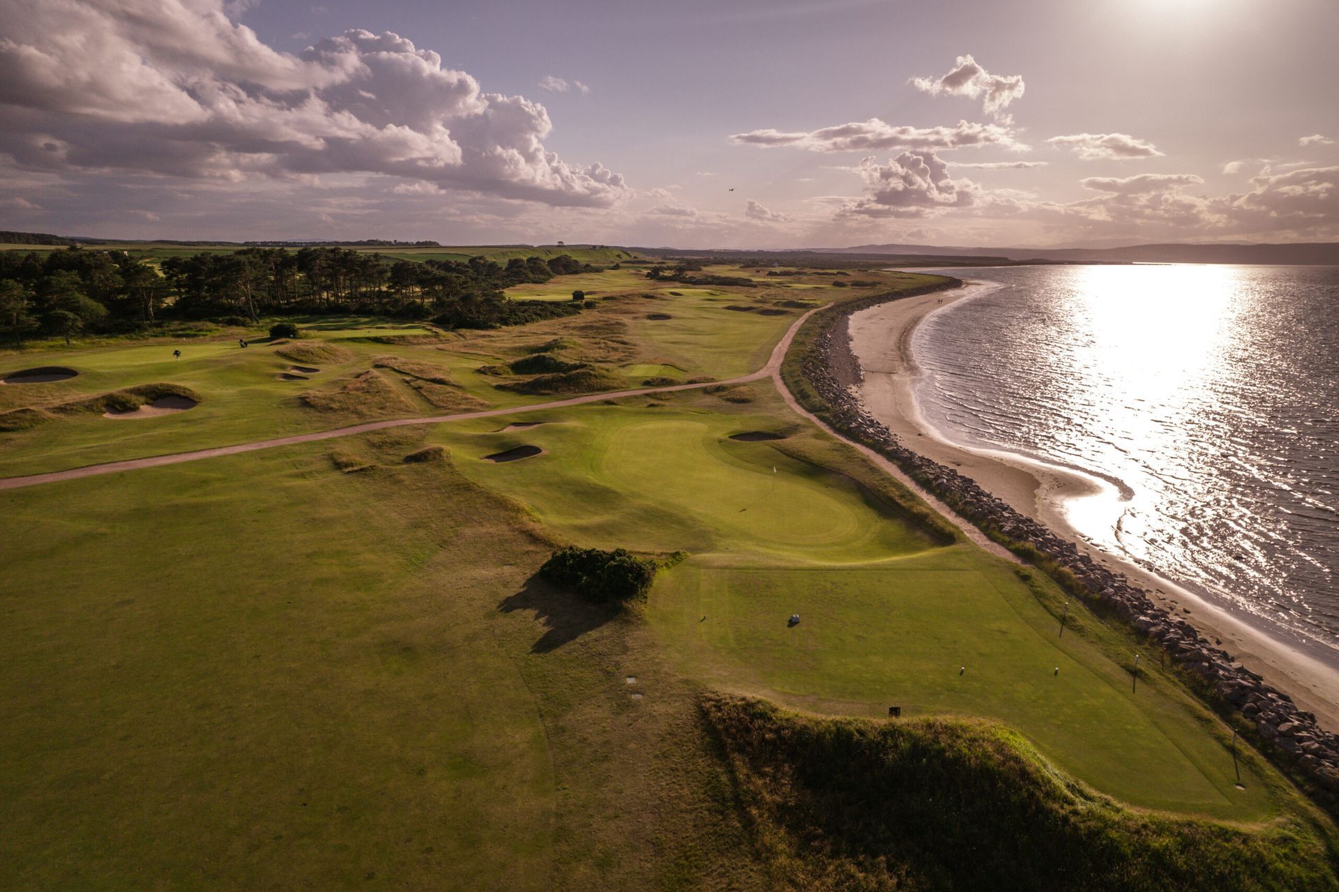An aerial view of a golf course next to the ocean