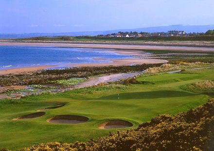 A golf course with a large body of water in the background