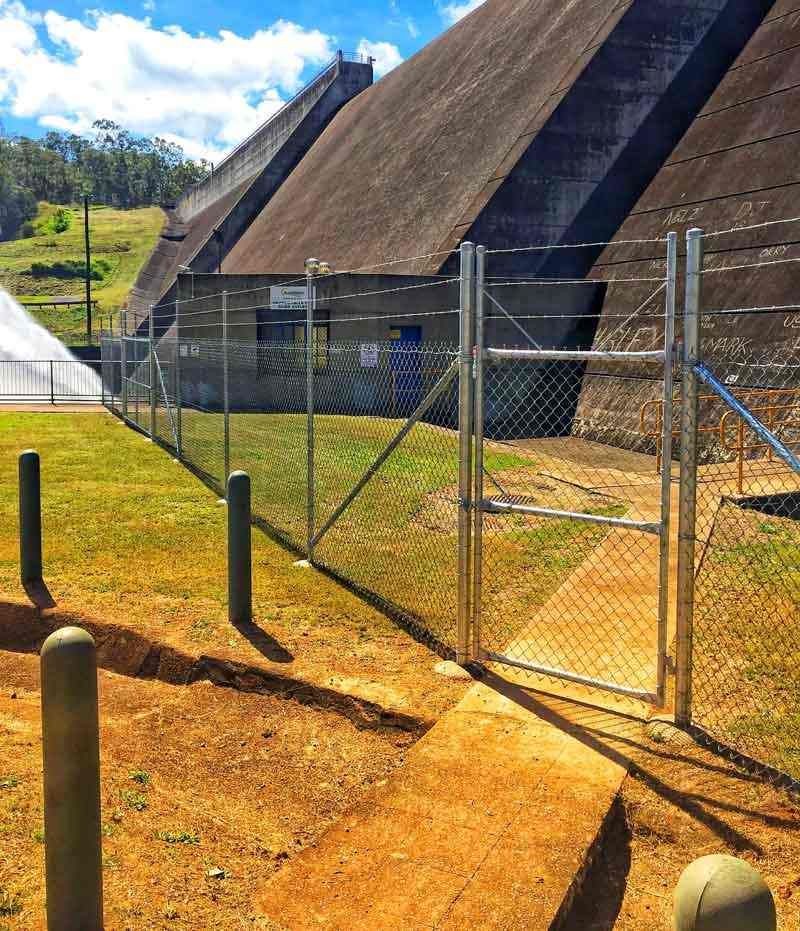 A Chain Link Fence is Surrounding a Large Building — Fencing Around In Mareeba, QLD