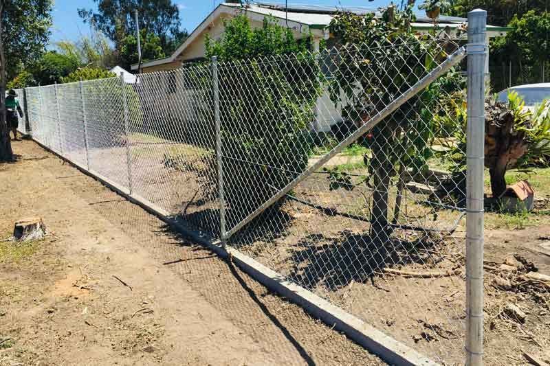 A Chain Link Fence is Being Built in Front of a House — Fencing Around In Mareeba, QLD