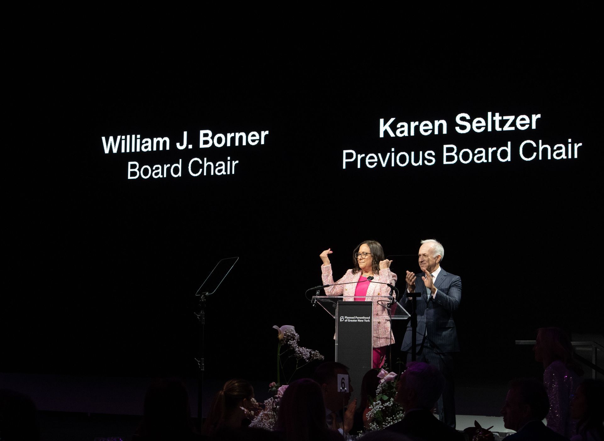 Planned Parenthood Event at The Glasshouse - photo of a man and a woman are standing at a podium in front of a crowd .