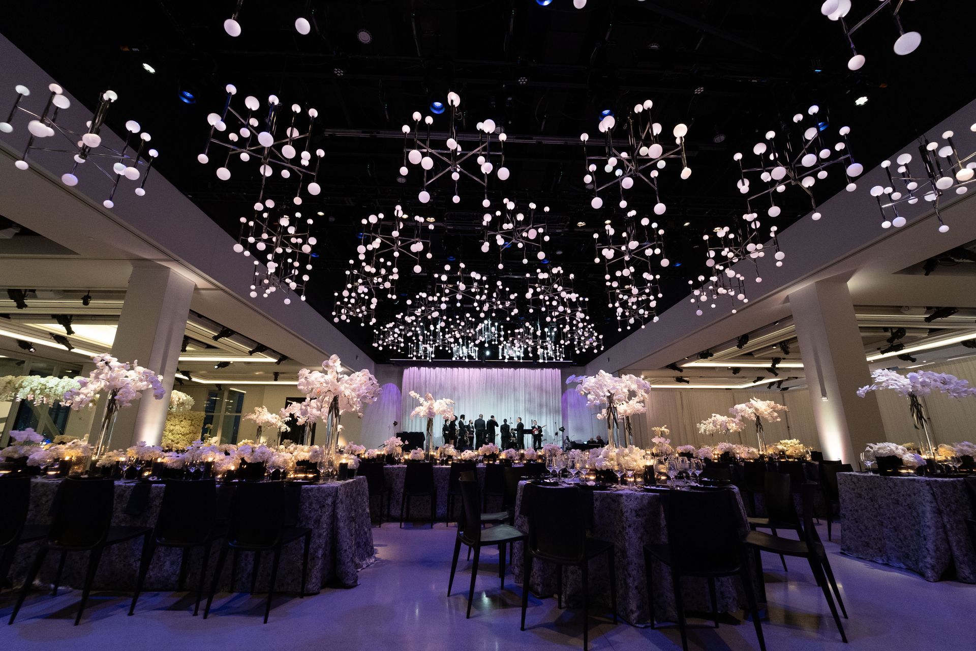 a large room with tables and chairs set up for a wedding reception .