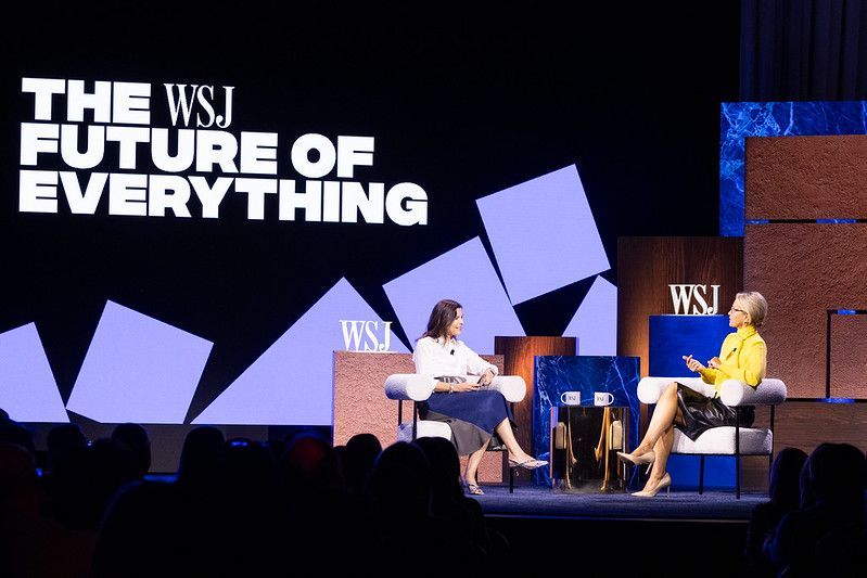 Two women in chairs on stage at 