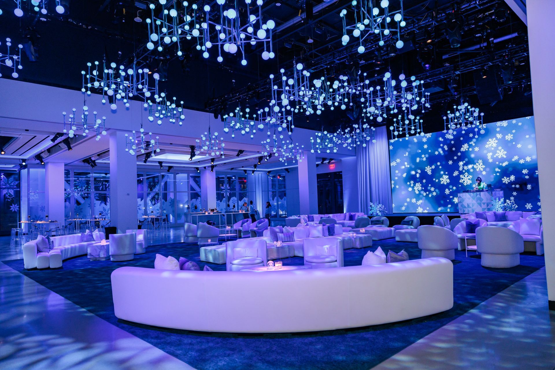 A large room filled with lots of furniture and purple lights.