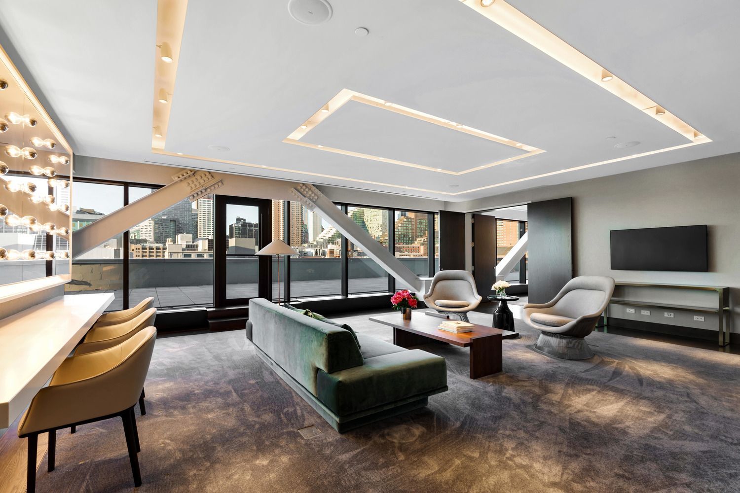 a living room with a couch , chairs , table and television .