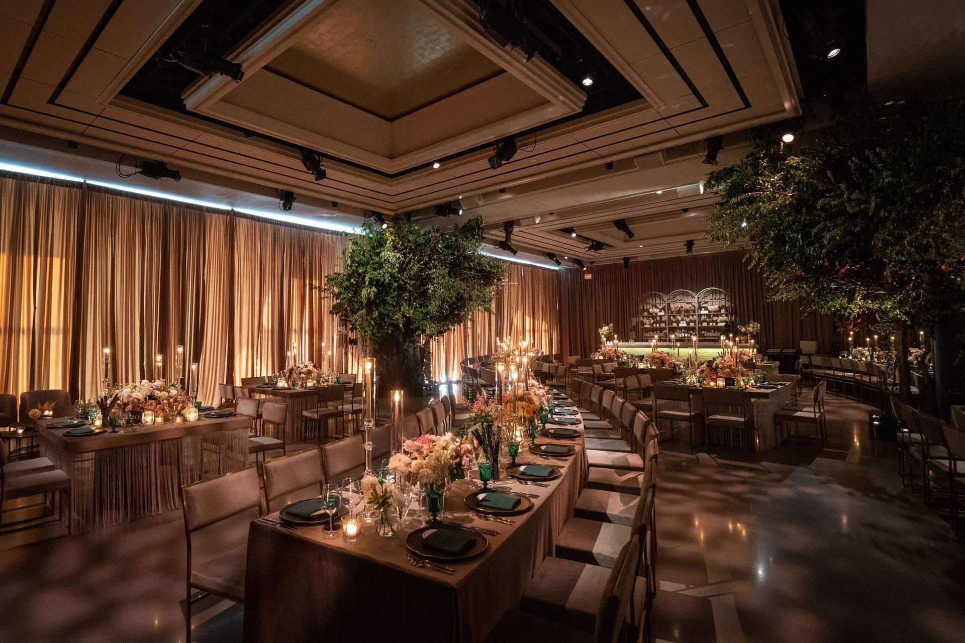 a large room with tables and chairs set up for a wedding reception .