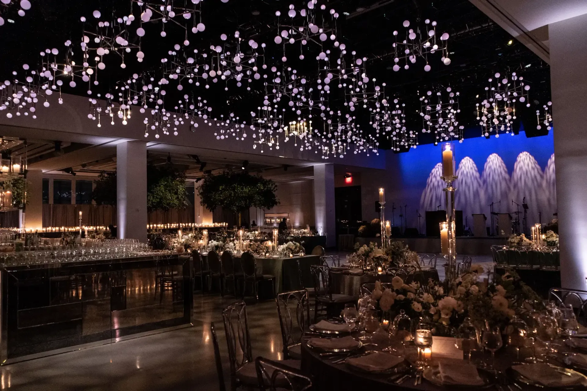 A large room with tables and chairs set up for a wedding reception.
