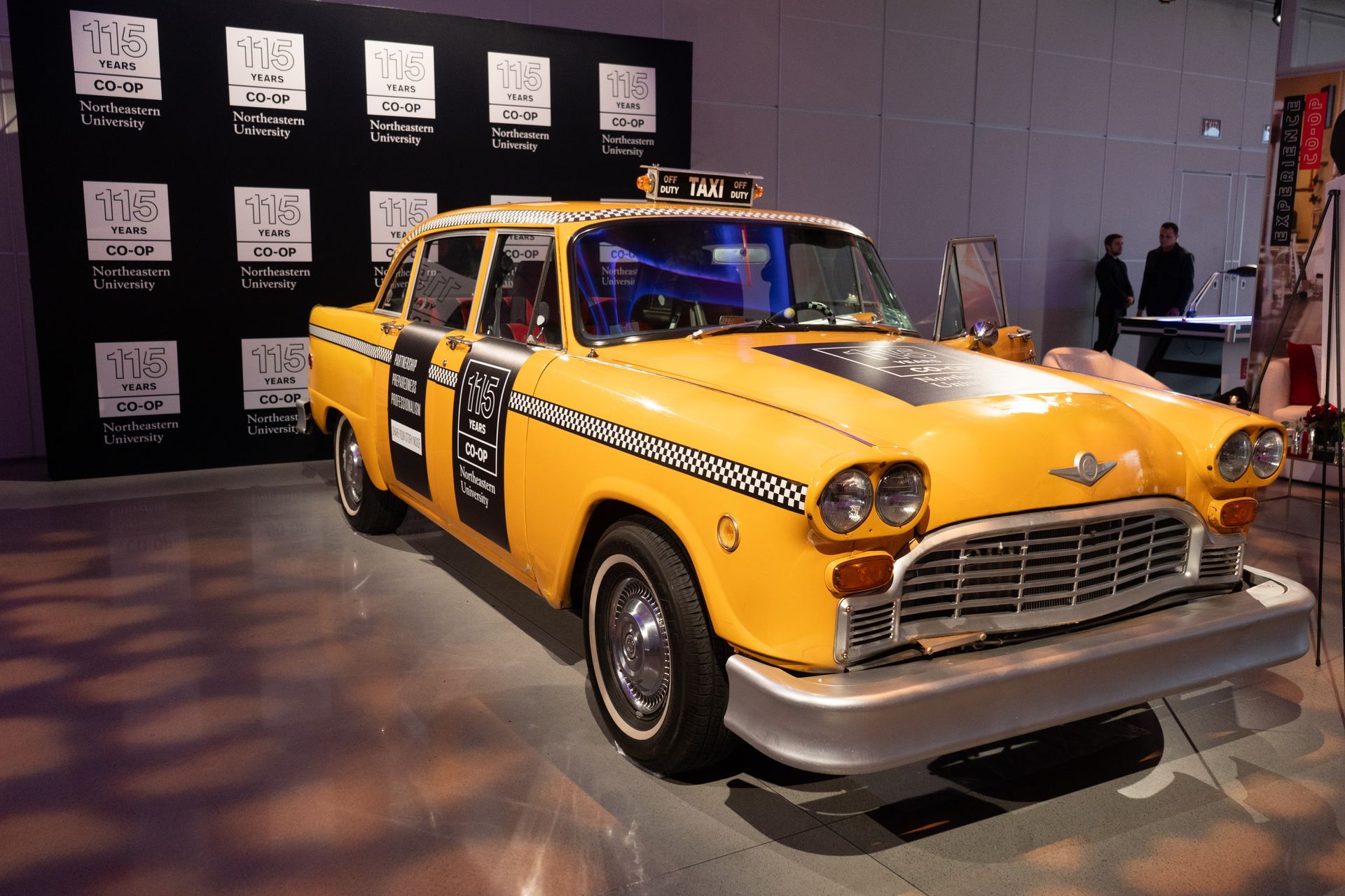A yellow taxi cab with the number 1 on the side