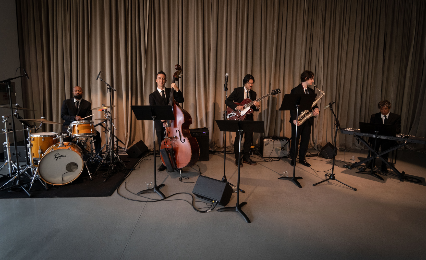 a group of men are playing instruments on a stage .